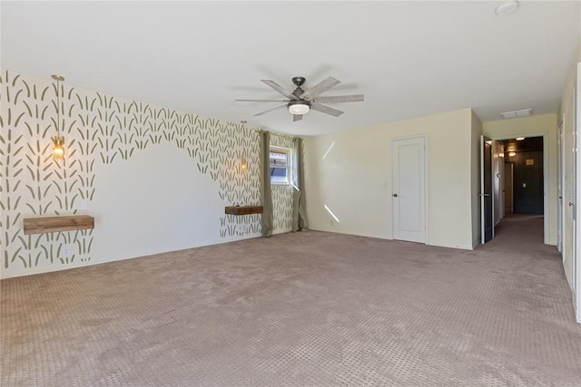 12600 Green Valley Dr, Oklahoma City, OK 73120 - carpeted spare room featuring wallpapered walls, a ceiling fan, and visible vents