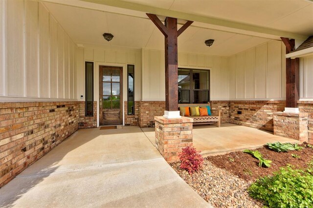 doorway to property with brick siding
