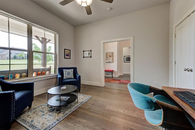 home office with ceiling fan, baseboards, and wood finished floors