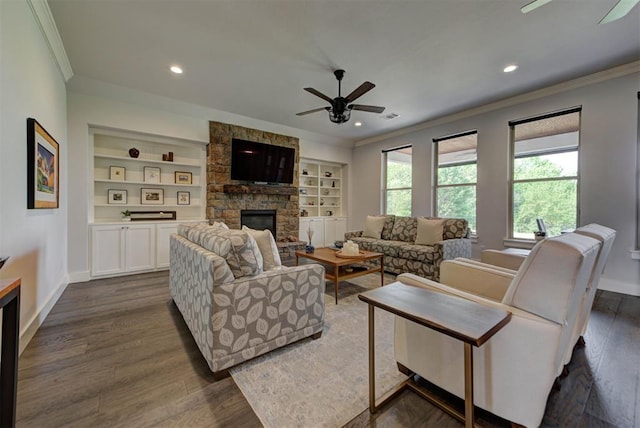 living room featuring a fireplace, crown molding, baseboards, and ceiling fan