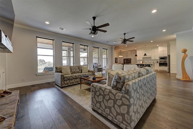 living area featuring baseboards, visible vents, recessed lighting, and ornamental molding
