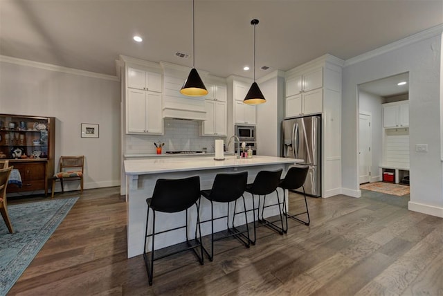 kitchen featuring backsplash, appliances with stainless steel finishes, baseboards, and ornamental molding