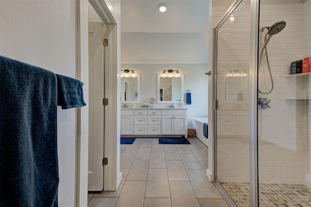 full bathroom featuring a shower stall, tile patterned flooring, double vanity, and a tub to relax in