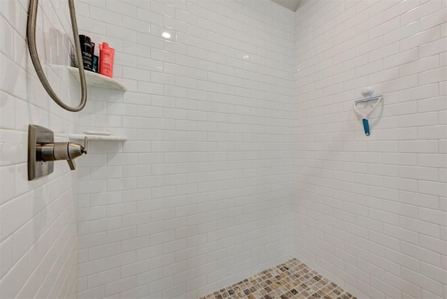 bathroom with tiled shower