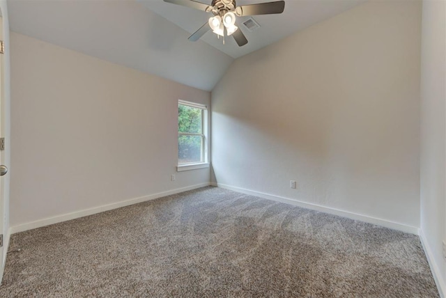 spare room featuring vaulted ceiling, a ceiling fan, carpet flooring, and visible vents