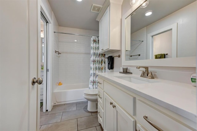 full bathroom with tile patterned floors, visible vents, toilet, vanity, and shower / bath combo with shower curtain