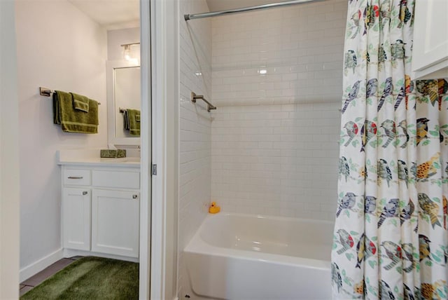 full bath with baseboards, vanity, and shower / tub combo with curtain