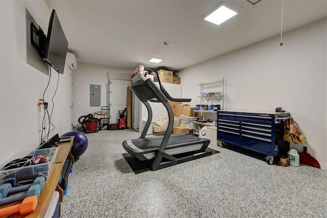 exercise room with attic access, carpet flooring, electric panel, and a wall unit AC