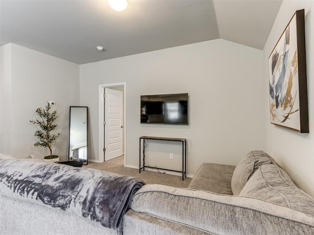 carpeted bedroom featuring lofted ceiling and baseboards