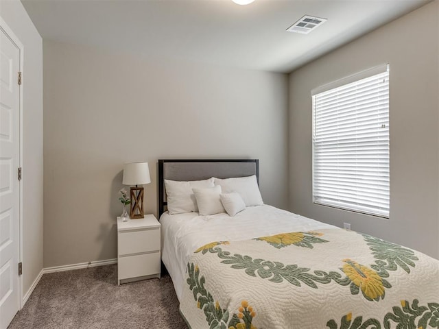 carpeted bedroom featuring baseboards