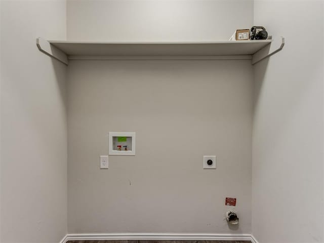 laundry area featuring electric dryer hookup, hookup for a washing machine, baseboards, and wood finished floors
