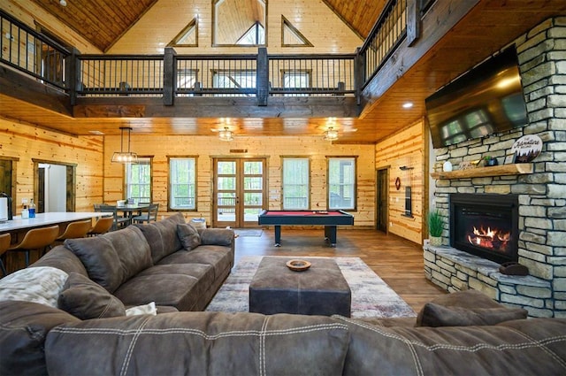 recreation room featuring wooden walls, wood finished floors, pool table, and high vaulted ceiling