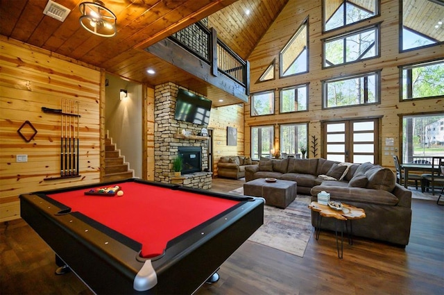 game room with visible vents, a towering ceiling, and wooden ceiling