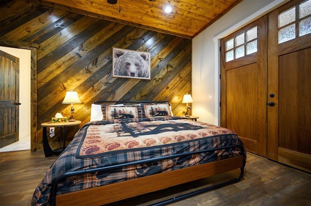 bedroom featuring wooden ceiling, vaulted ceiling, wood finished floors, and wooden walls