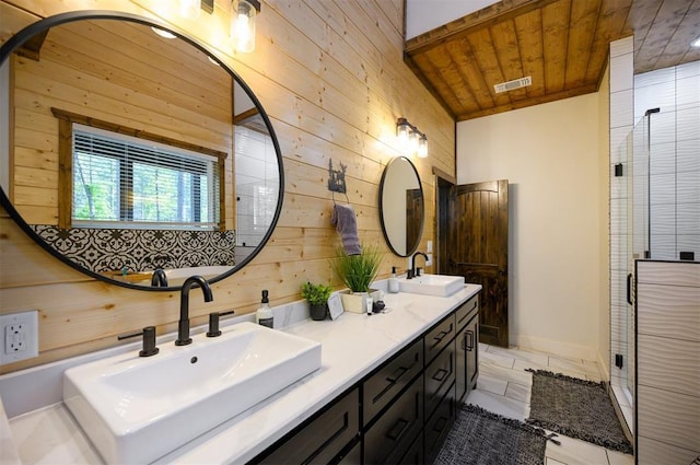 full bathroom featuring wood walls, a sink, visible vents, and a stall shower
