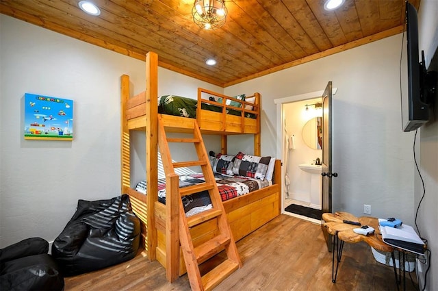 bedroom with recessed lighting, wood finished floors, a sink, wood ceiling, and ensuite bathroom