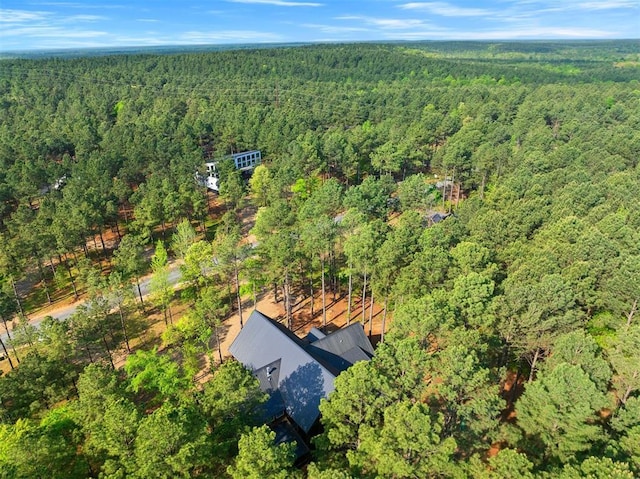 drone / aerial view featuring a forest view