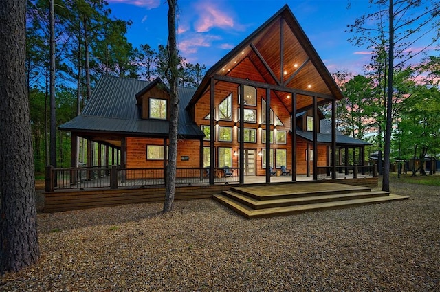 rear view of property featuring metal roof and a deck