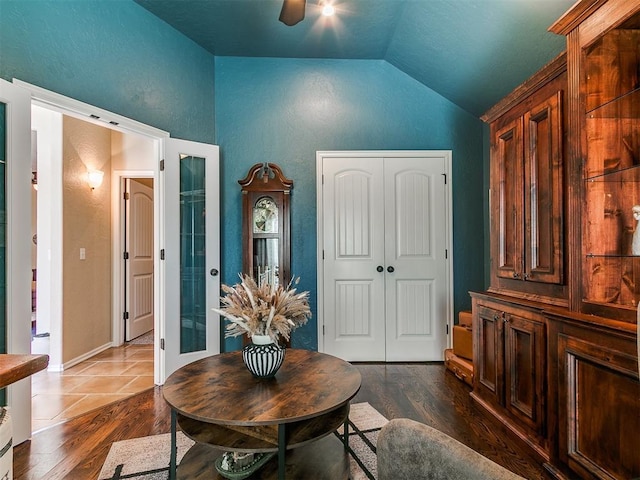 sitting room with ceiling fan, dark wood-style flooring, and lofted ceiling
