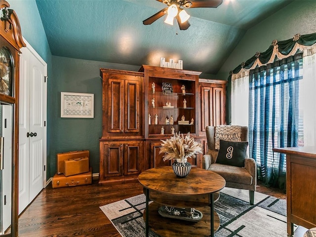 sitting room featuring a textured ceiling, ceiling fan, vaulted ceiling, and dark wood finished floors
