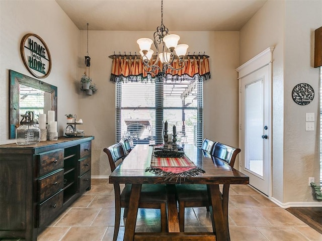 dining room with baseboards, a chandelier, and light tile patterned floors