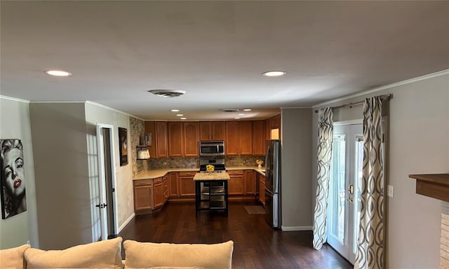 2813 Clermont Pl, Oklahoma City, OK 73116 - kitchen featuring stainless steel appliances, light countertops, ornamental molding, dark wood-style floors, and recessed lighting
