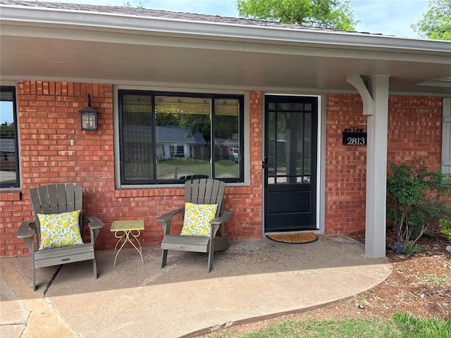 2813 Clermont Pl, Oklahoma City, OK 73116 - view of exterior entry with brick siding and a porch