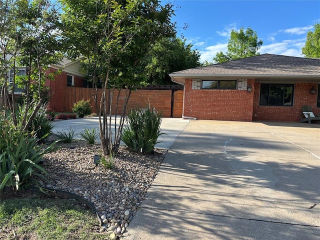 2813 Clermont Pl, Oklahoma City, OK 73116 - view of home's exterior featuring brick siding, fence, and driveway