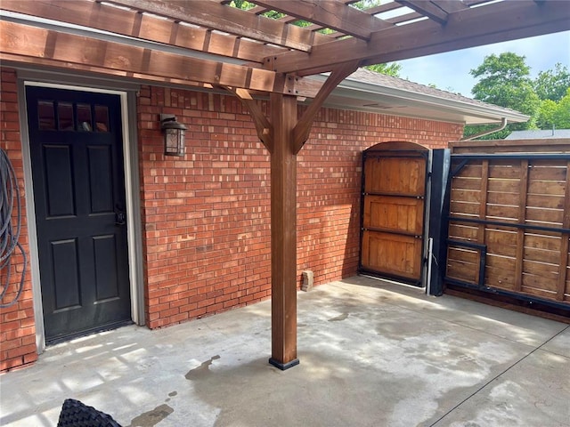 2813 Clermont Pl, Oklahoma City, OK 73116 - entrance to property with a gate, brick siding, a pergola, and a patio area