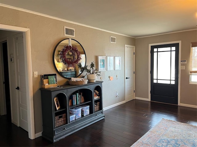 2813 Clermont Pl, Oklahoma City, OK 73116 - entryway featuring wood finished floors, a textured wall, baseboards, and crown molding