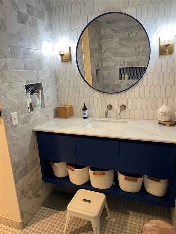 2813 Clermont Pl, Oklahoma City, OK 73116 - bathroom with decorative backsplash, vanity, and tile walls
