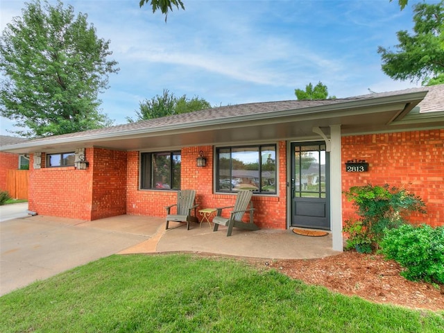 2813 Clermont Pl, Oklahoma City, OK 73116 - back of house featuring brick siding, a shingled roof, and a patio