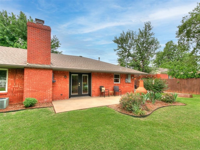 2813 Clermont Pl, Oklahoma City, OK 73116 - rear view of property with a chimney, brick siding, roof with shingles, and a patio