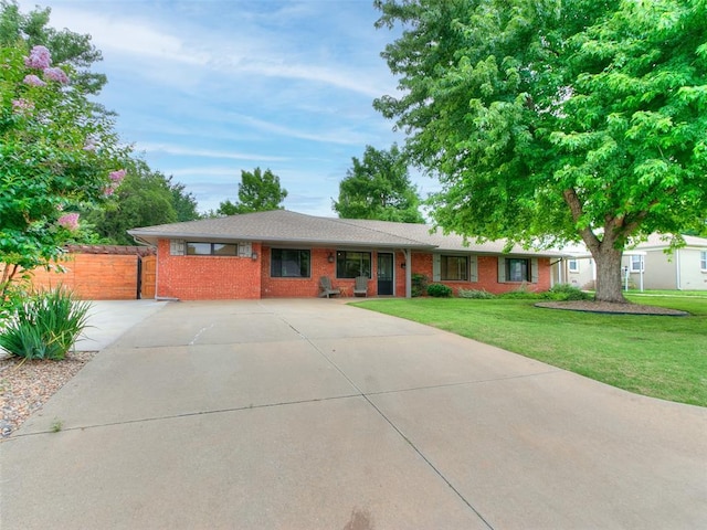 2813 Clermont Pl, Oklahoma City, OK 73116 - ranch-style home featuring brick siding, a front yard, and concrete driveway