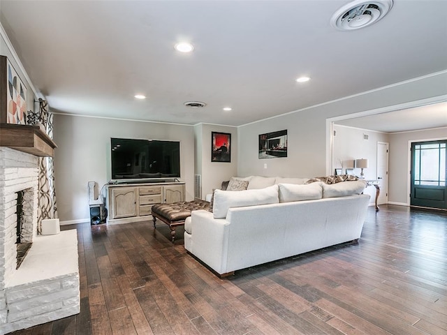 2813 Clermont Pl, Oklahoma City, OK 73116 - living area with dark wood-style flooring, crown molding, a brick fireplace, and recessed lighting