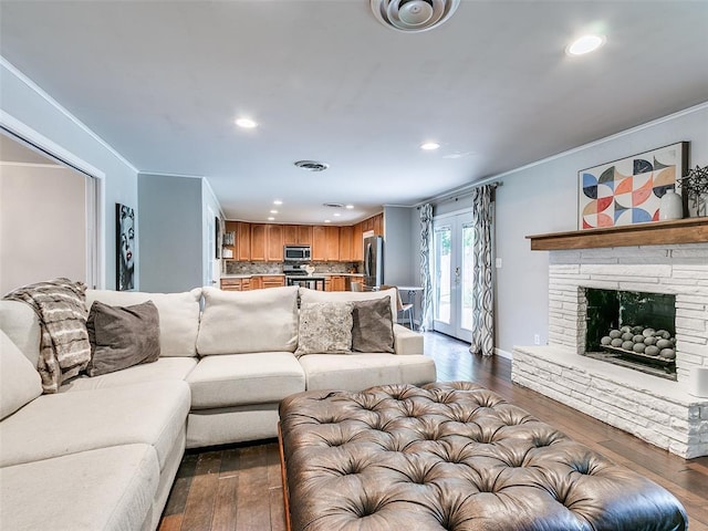 2813 Clermont Pl, Oklahoma City, OK 73116 - living room with ornamental molding, dark wood-style flooring, recessed lighting, french doors, and a fireplace