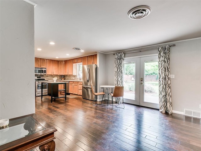 2813 Clermont Pl, Oklahoma City, OK 73116 - kitchen with appliances with stainless steel finishes, french doors, light countertops, dark wood finished floors, and recessed lighting