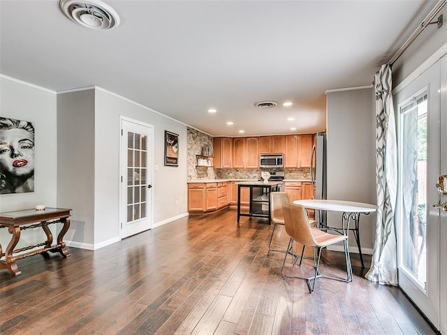 2813 Clermont Pl, Oklahoma City, OK 73116 - kitchen featuring stainless steel appliances, french doors, recessed lighting, dark wood-style floors, and light countertops