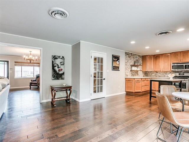 2813 Clermont Pl, Oklahoma City, OK 73116 - kitchen with appliances with stainless steel finishes, crown molding, a chandelier, open shelves, and light countertops
