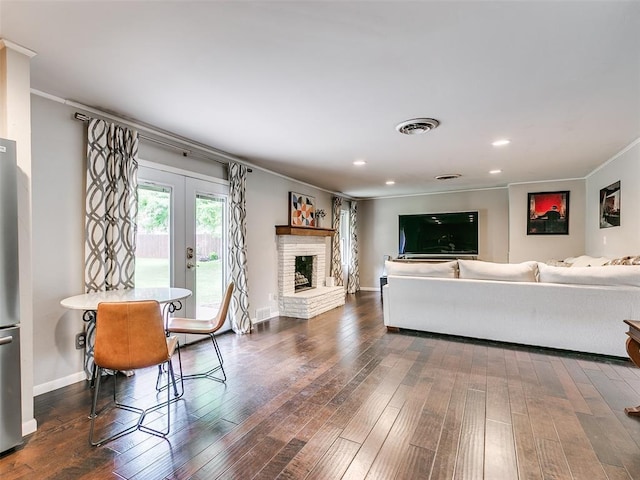 2813 Clermont Pl, Oklahoma City, OK 73116 - living room featuring crown molding, wood finished floors, french doors, a brick fireplace, and recessed lighting