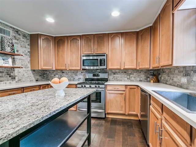 2813 Clermont Pl, Oklahoma City, OK 73116 - kitchen with appliances with stainless steel finishes, dark wood-style floors, backsplash, a kitchen bar, and crown molding