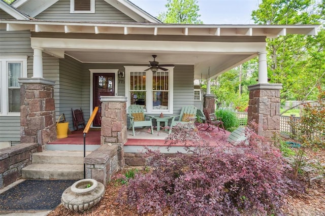 entrance to property featuring covered porch and a ceiling fan
