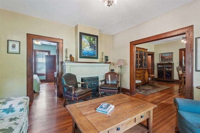 living area with hardwood / wood-style floors and a brick fireplace