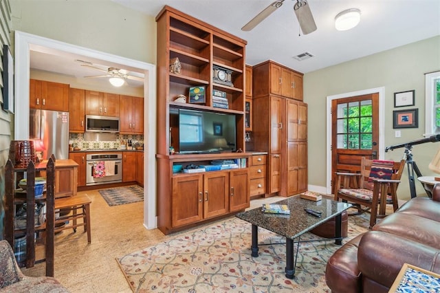 living area with a ceiling fan and light floors