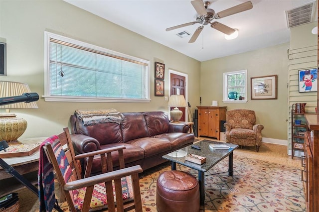 living room with a ceiling fan and baseboards