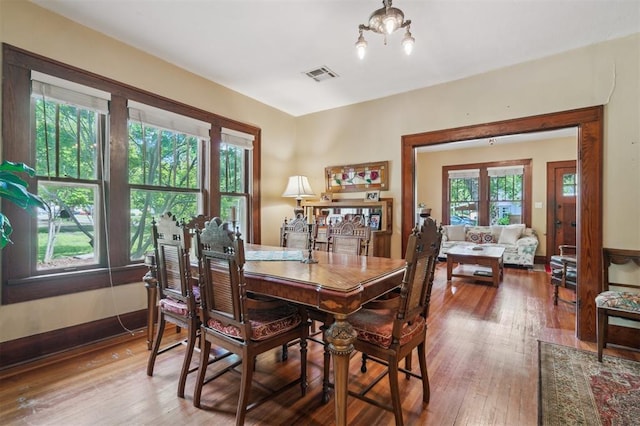 dining space with hardwood / wood-style floors
