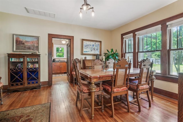 dining space featuring hardwood / wood-style flooring and baseboards