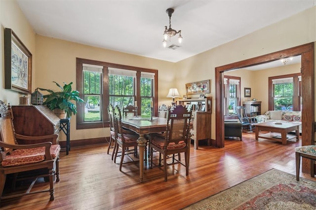 dining space with wood finished floors and baseboards