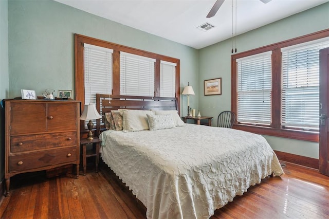 bedroom featuring wood-type flooring, ceiling fan, and baseboards