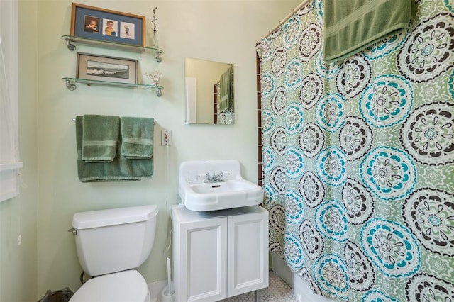 bathroom with toilet, vanity, a shower with shower curtain, and tile patterned floors